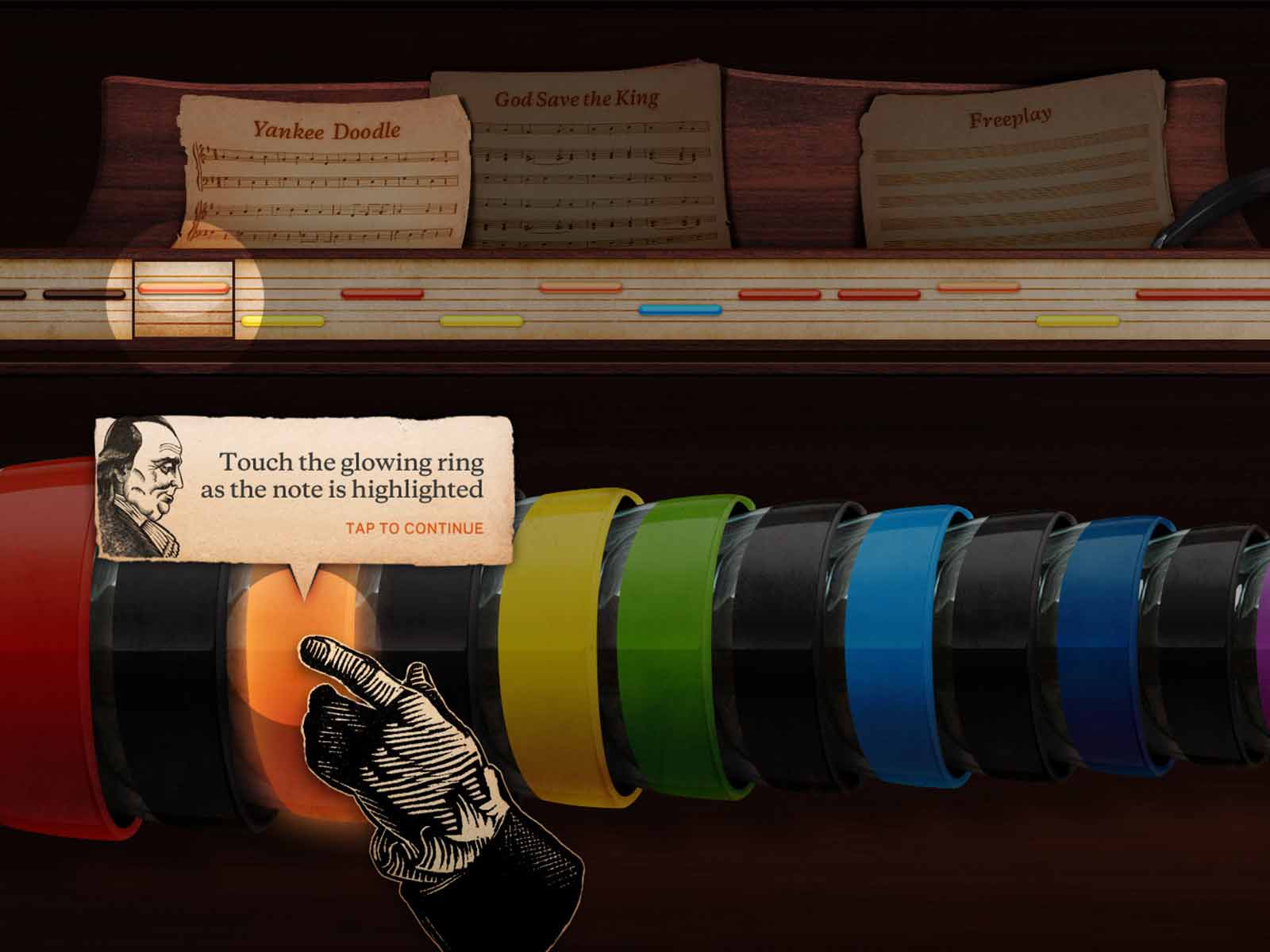 Screen shot of the glass armonica interactive, showing a hand reaching out to colored bowls.