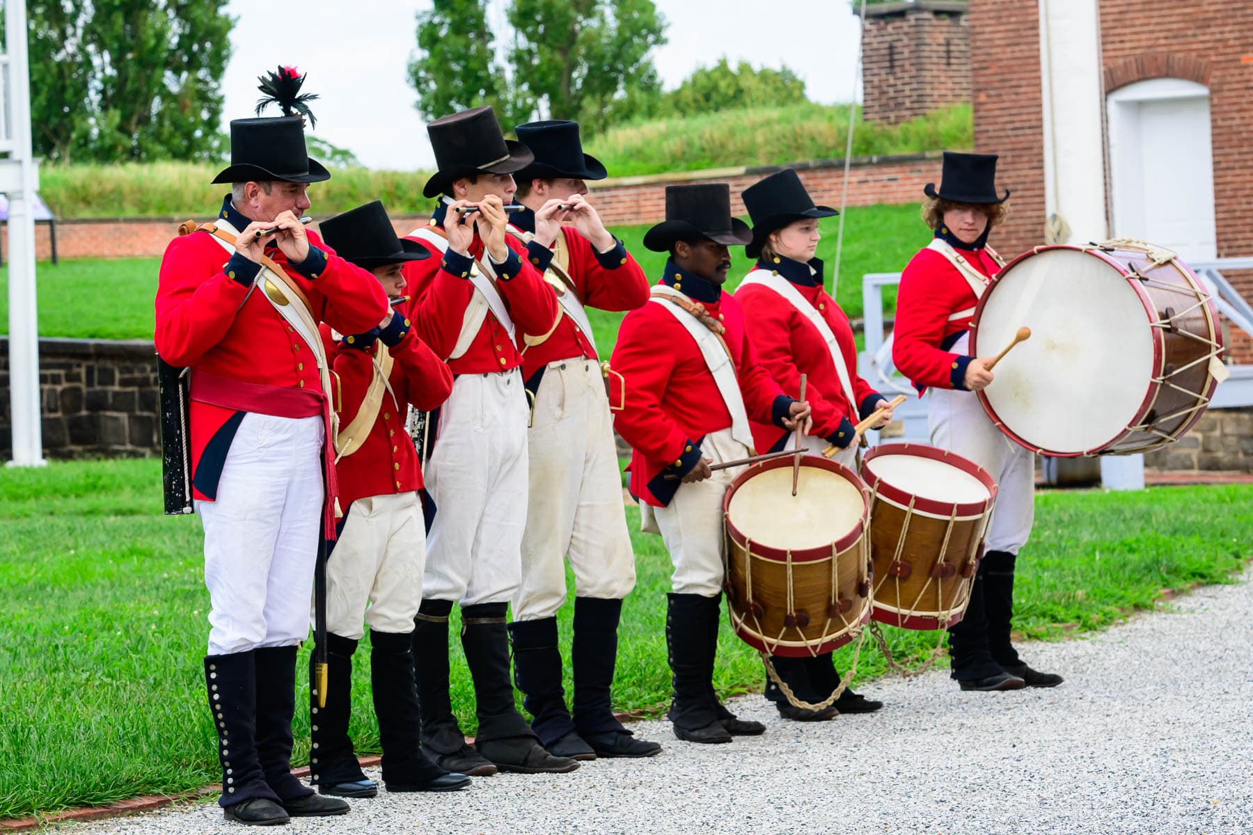 Living history members performing fifes and drums inside star fort.