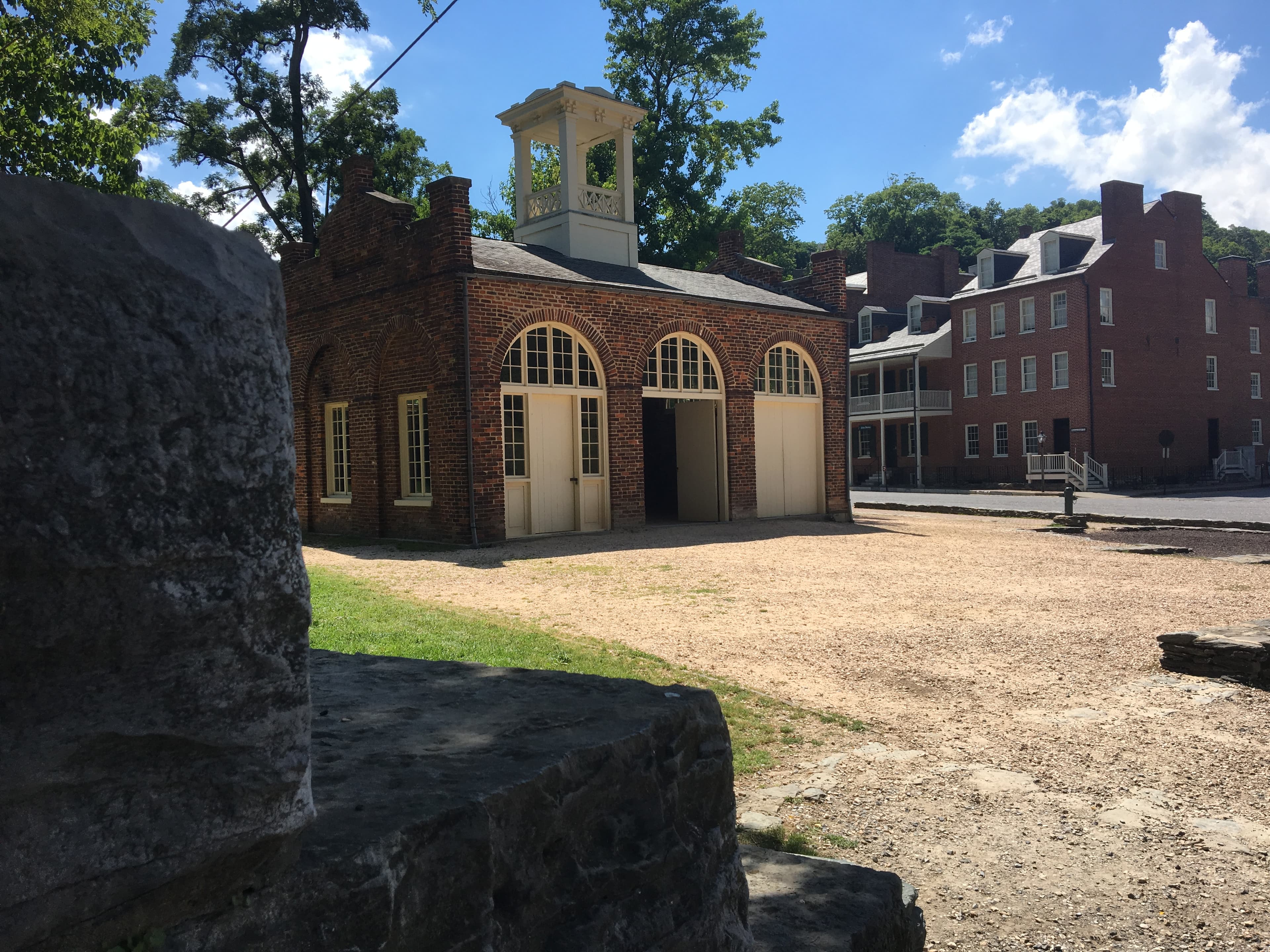 small brick building that is John Brown's Fort with other Lower Town buildings in the background