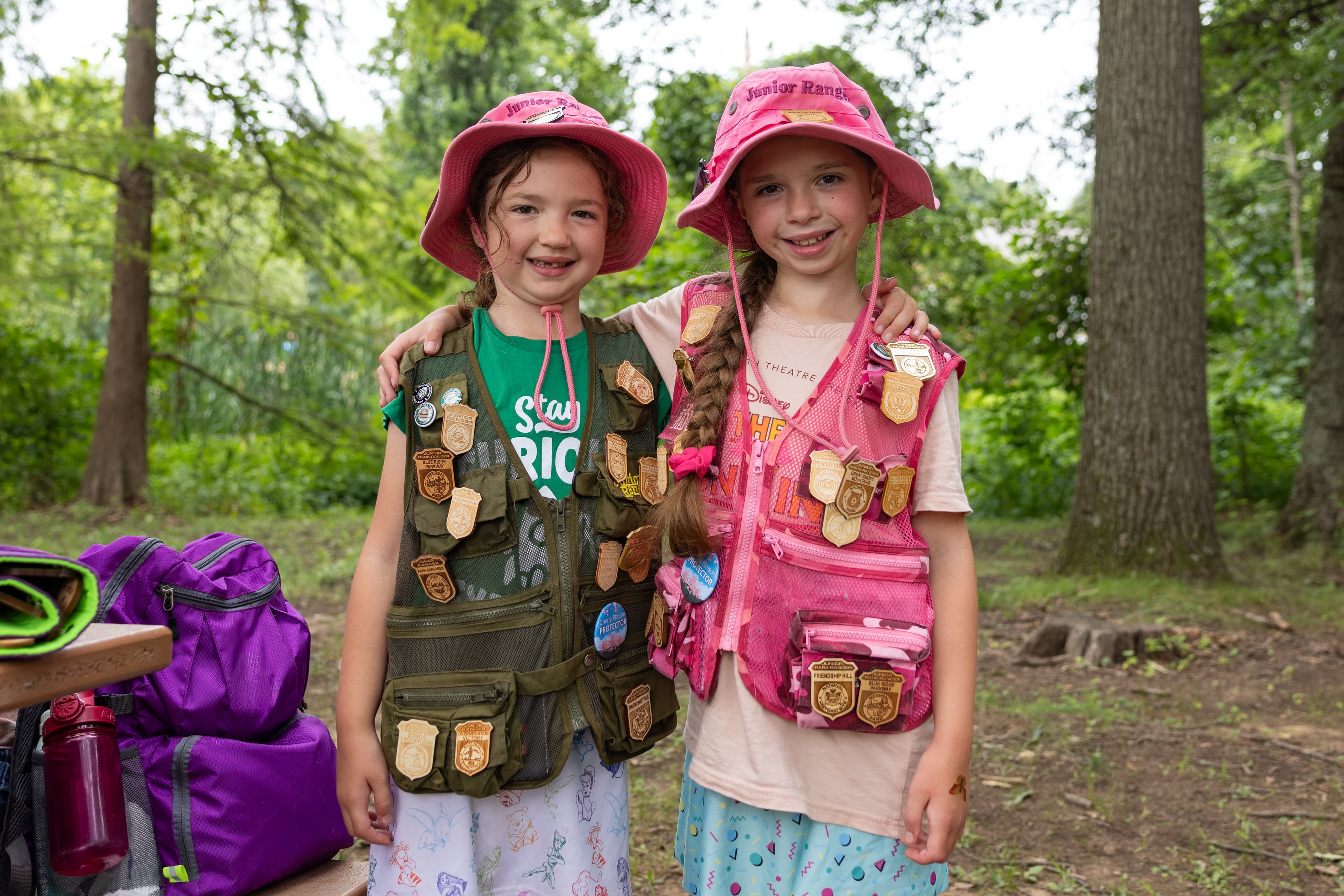 Two Junior Rangers display their Junior Ranger badge collections at Kenilworth Aquatic Gardens
